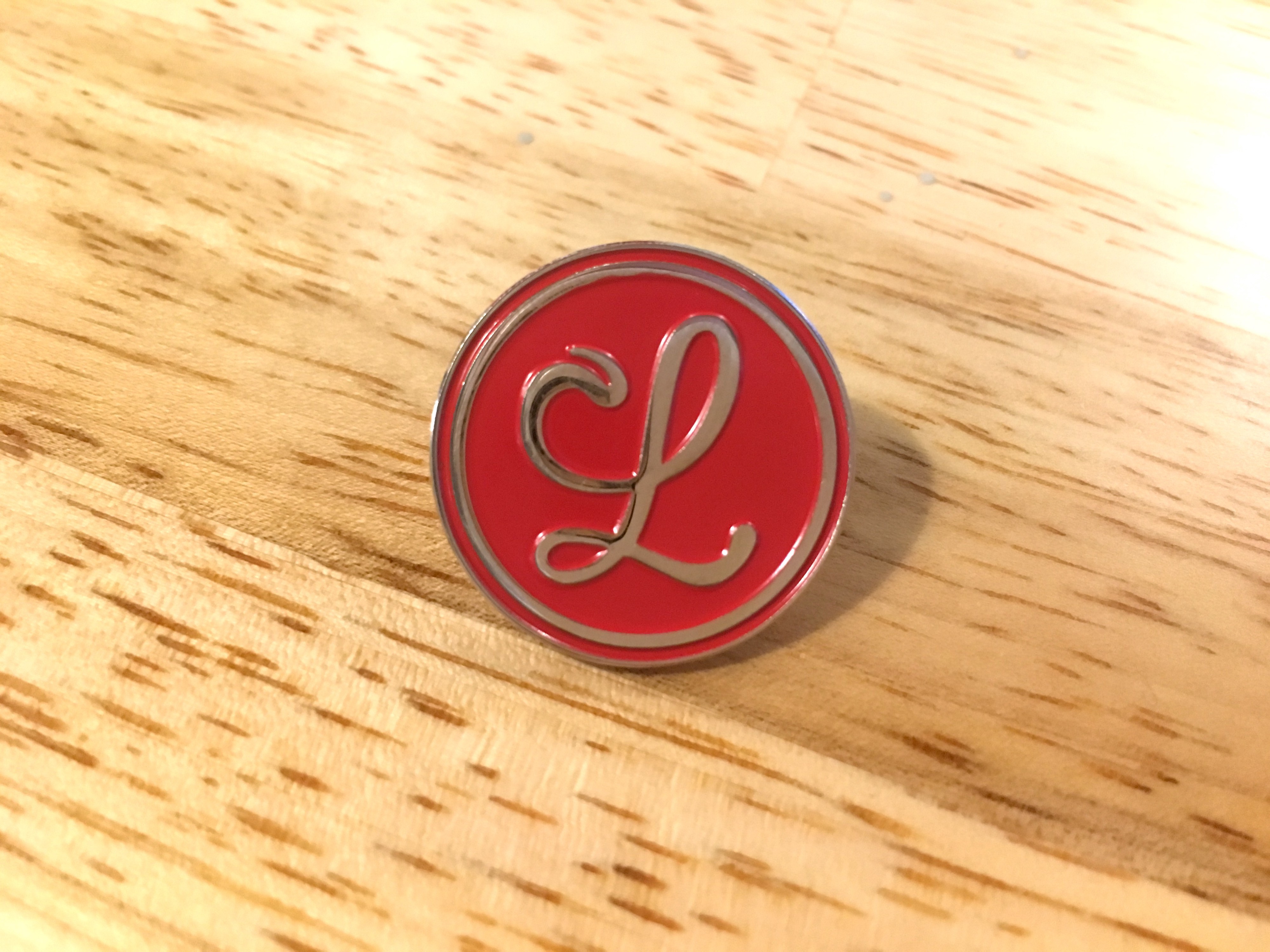 A logo enamel pin.