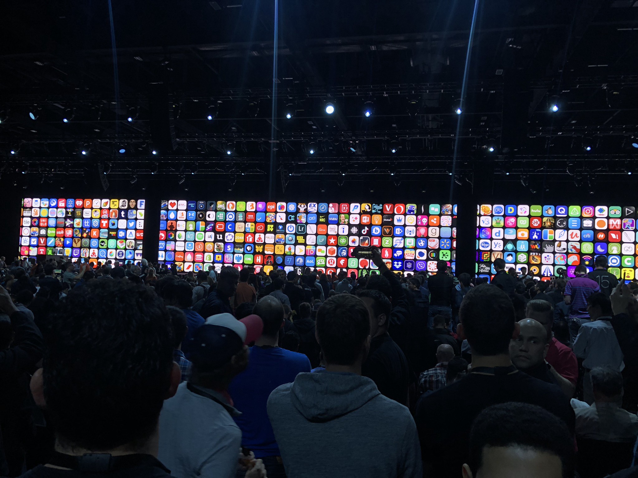 Photo of the WWDC keynote showing a wall of app icons.